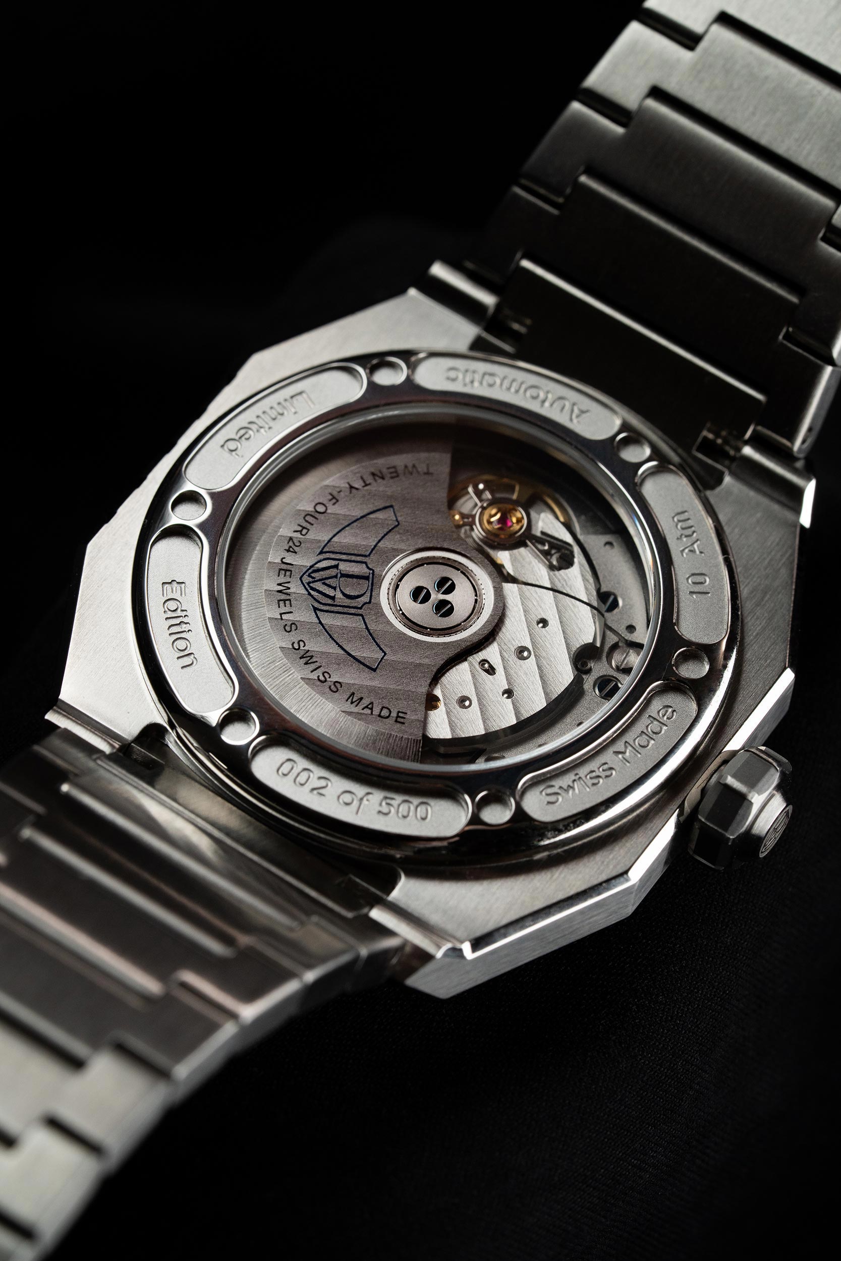 Close-up of a mechanical watch with visible brand name on a dark background. Model DWISS A1- using a Swiss made automatic movement La Joux-Perret G100 Soigné with 68 hours power reserve and white superLumiNova blocks